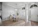 Open-concept dining area featuring wood-look tile, modern light fixture, and neutral walls at 3633 Cordgrass Dr, Valrico, FL 33596
