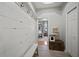 Welcoming entryway with board and batten accent wall, storage bench, and access to bedroom at 3633 Cordgrass Dr, Valrico, FL 33596