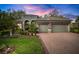 Beautiful one-story home with a three-car garage, stone accents, and lush landscaping at 3633 Cordgrass Dr, Valrico, FL 33596