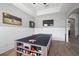 Bright game room featuring a ping pong table, TV, dart board, and wood-look flooring at 3633 Cordgrass Dr, Valrico, FL 33596