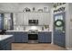 Updated kitchen featuring blue and white cabinets, stainless steel appliances, and pendant lighting at 3633 Cordgrass Dr, Valrico, FL 33596