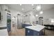 Contemporary kitchen featuring two-tone cabinets, stainless steel appliances, and pendant lights at 3633 Cordgrass Dr, Valrico, FL 33596