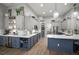Modern kitchen with two-tone cabinetry, stainless steel appliances, and a spacious island at 3633 Cordgrass Dr, Valrico, FL 33596