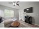 Bright living room with modern furnishings, wood flooring, a ceiling fan and a tv on the wall at 3633 Cordgrass Dr, Valrico, FL 33596