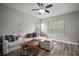 Spacious living room with hardwood floors, comfortable white sofa and natural light at 3633 Cordgrass Dr, Valrico, FL 33596
