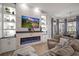 Bright living room with a modern fireplace, built-in shelves, and a large sectional sofa at 3633 Cordgrass Dr, Valrico, FL 33596