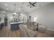 Spacious open concept with living room and kitchen area features a sectional couch and bright interiors at 3633 Cordgrass Dr, Valrico, FL 33596