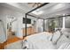 Bright and airy main bedroom with hardwood floors, a four-poster bed, and TV at 3633 Cordgrass Dr, Valrico, FL 33596