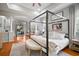 Relaxing main bedroom with hardwood floors, four-poster bed, and ample natural light at 3633 Cordgrass Dr, Valrico, FL 33596