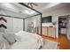 Well-lit main bedroom with an open layout, hardwood floors, and access to a walk-in closet at 3633 Cordgrass Dr, Valrico, FL 33596