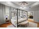 Spacious main bedroom with a four poster bed and a ensuite bathroom at 3633 Cordgrass Dr, Valrico, FL 33596