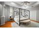 Bright main bedroom featuring a decorative ceiling fan, four-poster bed, and hardwood flooring at 3633 Cordgrass Dr, Valrico, FL 33596