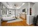 Open main bedroom featuring a hardwood floors, four-poster bed, walk-in closet, and TV at 3633 Cordgrass Dr, Valrico, FL 33596