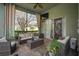 Screened patio with brick floors, ceiling fan and comfortable furniture at 3633 Cordgrass Dr, Valrico, FL 33596