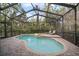 A kidney shaped pool features a raised spa and lounge seating, perfect for relaxation at 3633 Cordgrass Dr, Valrico, FL 33596