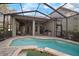 Aerial view of pool, lanai, and backyard of home with covered seating and outdoor grill at 3633 Cordgrass Dr, Valrico, FL 33596