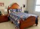 Inviting bedroom with traditional wood furniture and cozy floral bedding and plenty of natural light at 3709 Gallagher Rd, Plant City, FL 33565