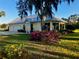 Beautiful exterior of the home with lush landscaping and a metal roof, offering a blend of comfort and style at 3709 Gallagher Rd, Plant City, FL 33565