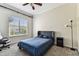 A calming bedroom featuring a cozy bed with blue bedding and a window with natural light at 402 S Armenia Ave # 137, Tampa, FL 33609