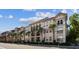 Attractive condominium building featuring neutral stucco, Mediterranean style roof, and decorative pillars and trees at 402 S Armenia Ave # 137, Tampa, FL 33609