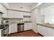 Bright kitchen featuring white cabinets, stainless steel appliances, granite countertops, and hardwood floors at 402 S Armenia Ave # 137, Tampa, FL 33609