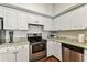 Bright kitchen featuring white cabinets, stainless steel appliances, granite countertops, and hardwood floors at 402 S Armenia Ave # 137, Tampa, FL 33609
