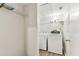 Bright laundry room with wood-look floors and stacked washer and dryer at 402 S Armenia Ave # 137, Tampa, FL 33609