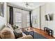 Cozy living room featuring hardwood floors, neutral paint, ceiling fan, large windows, and comfortable sofa at 402 S Armenia Ave # 137, Tampa, FL 33609
