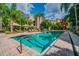 Inviting community pool with crystal clear water and surrounding lounge chairs at 402 S Armenia Ave # 137, Tampa, FL 33609