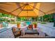 Inviting pool with comfortable seating under shaded canopy umbrellas at 402 S Armenia Ave # 137, Tampa, FL 33609
