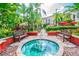 Hot tub nestled among lush landscaping and benches in an outdoor space at 402 S Armenia Ave # 137, Tampa, FL 33609