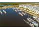 Aerial view showcasing a waterfront condo community with boat docks and a picturesque harbor filled with boats at 418 Bahia Beach Blvd, Ruskin, FL 33570