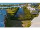Scenic aerial view of waterfront condos, lush greenery, and a marina filled with boats on a sunny day at 418 Bahia Beach Blvd, Ruskin, FL 33570