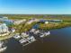 Bird's-eye view of waterfront community, featuring docks, condos, and natural surrounding landscapes at 418 Bahia Beach Blvd, Ruskin, FL 33570