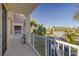 Second story balcony in a community with palm trees, street and beautiful blue sky at 418 Bahia Beach Blvd, Ruskin, FL 33570