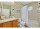 Cozy bathroom featuring a vanity with a sink, a toilet, and a bathtub-shower combination with a round window at 418 Bahia Beach Blvd, Ruskin, FL 33570