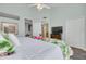 Bright bedroom featuring a white comforter with tropical floral accents and a TV atop a wooden dresser at 418 Bahia Beach Blvd, Ruskin, FL 33570