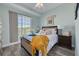 Comfortable bedroom showcasing a queen bed with a decorative headboard, adorned with a yellow tasseled blanket at 418 Bahia Beach Blvd, Ruskin, FL 33570