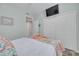 Well-lit bedroom featuring a comfortable bed, a TV, and ample closet space, complemented by light blue walls at 418 Bahia Beach Blvd, Ruskin, FL 33570