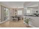 Bright dining area with a chandelier, adjacent to the kitchen, and featuring access to an outdoor balcony at 418 Bahia Beach Blvd, Ruskin, FL 33570