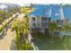 Exterior aerial view of a three story waterfront condo with balconies, tropical landscaping, and covered parking at 418 Bahia Beach Blvd, Ruskin, FL 33570
