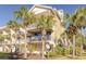 Building exterior surrounded by palm trees and featuring multiple balconies at 418 Bahia Beach Blvd, Ruskin, FL 33570