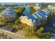 Exterior aerial view of waterfront condominiums with balconies, palm trees, parking, and lovely bay views at 418 Bahia Beach Blvd, Ruskin, FL 33570