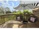 Relaxing outdoor balcony featuring a black-and-white umbrella, chairs, and table at 4740 Legacy Park Dr, Tampa, FL 33611