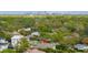 An aerial view shows the home nestled among lush greenery, close to the city at 4806 W San Rafael St, Tampa, FL 33629