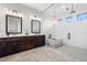 Bright bathroom with double vanity, soaking tub, glass shower, and modern lighting at 4806 W San Rafael St, Tampa, FL 33629