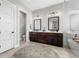 Bright bathroom featuring double vanity, modern fixtures, soaking tub, and linen closet at 4806 W San Rafael St, Tampa, FL 33629