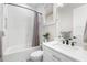 Bright bathroom featuring subway tile, a shower-tub combo and a white vanity with matte black hardware at 4806 W San Rafael St, Tampa, FL 33629