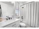 Modern bathroom featuring subway tile, a shower-tub combo and a white vanity with matte black hardware at 4806 W San Rafael St, Tampa, FL 33629