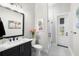 Modern bathroom with sleek black vanity, stylish mirror, and a glass-enclosed shower at 4806 W San Rafael St, Tampa, FL 33629